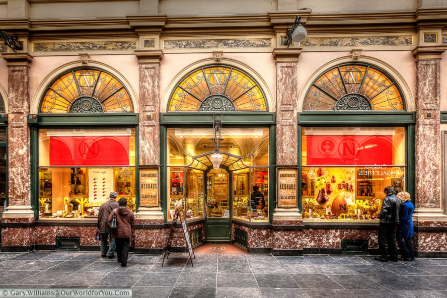 Passers by admire the work of chocolatiers in the Galeries Royales Saint-Hubert arcade in Brussels