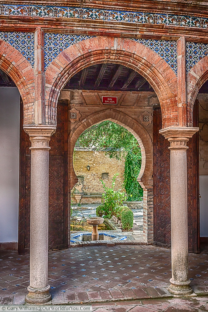 An arch leading to the garden in the Palacio de Mondragón, Ronda, Spain