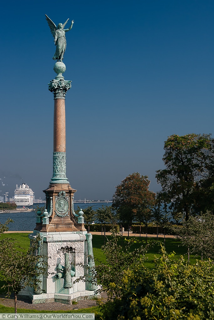 A view of the Ivar Huitfeldt Column in Langelinie, Copenhagen, with a cruise ship moored in the background..