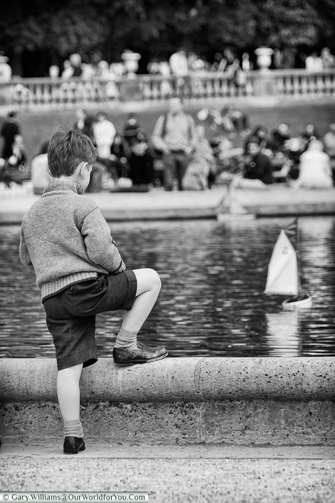 Little boy sailing in Le Jardin du Luxembourg, Paris, France
