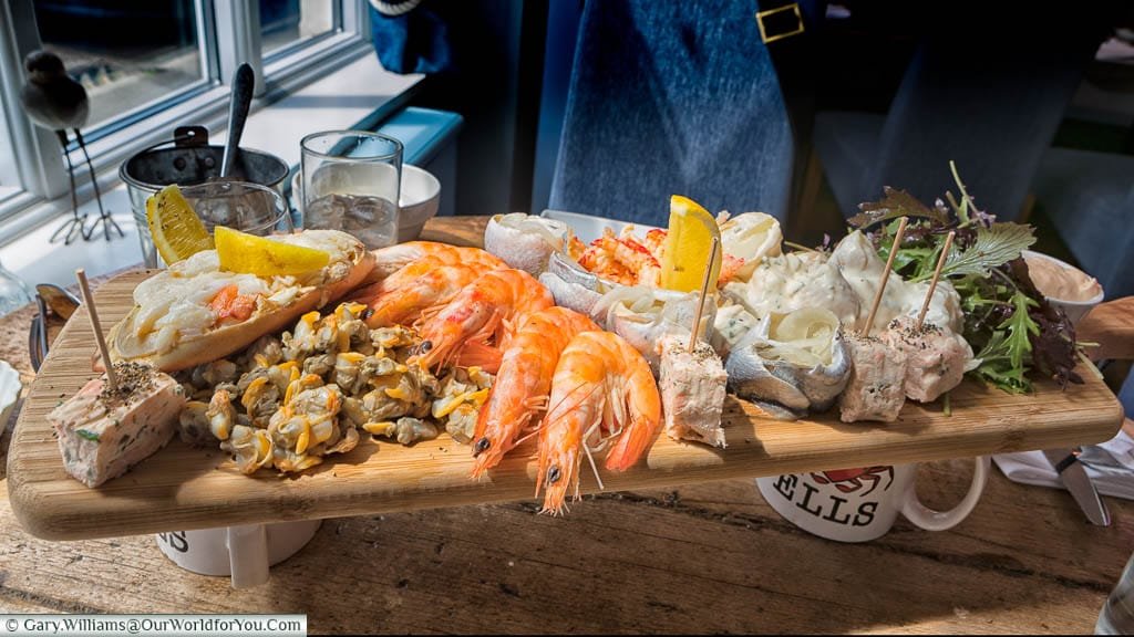 A seafood platter for two served on a wooden board at the Wells Crab House in Wells-next-the-Sea, Norfolk