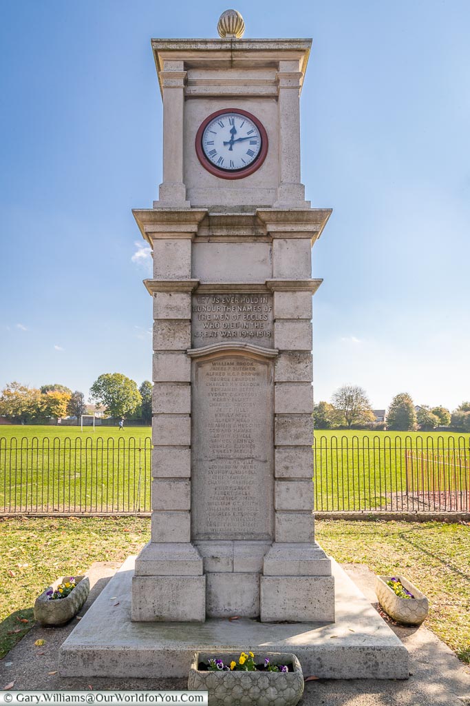 The Eccles War memorial, incorporating a clock in the simple stone column.