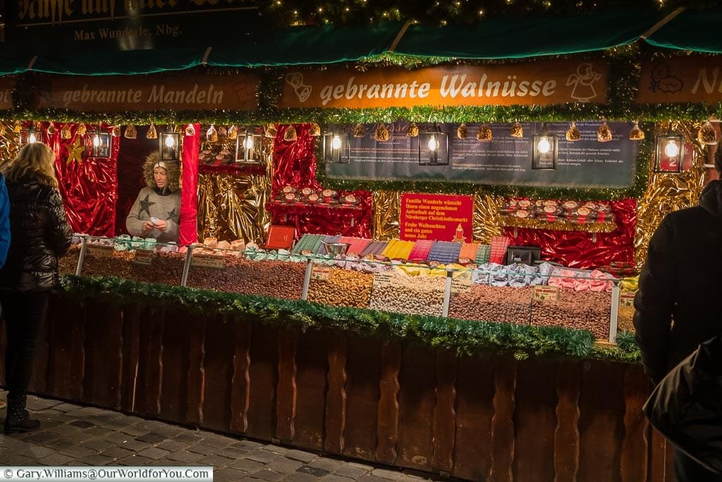 A nut seller offering sweet sticky nuts on a German Christmas Market stall in Nuremberg
