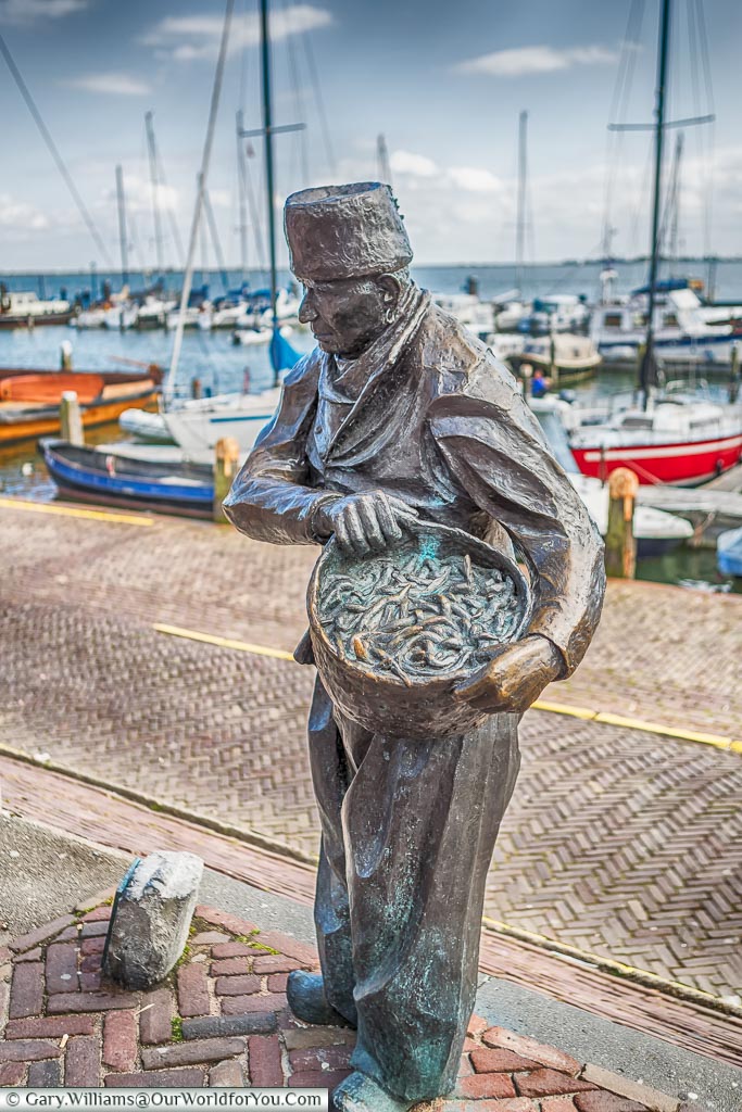 A statue to the trades in Volendam harbour, Holland, Netherlands