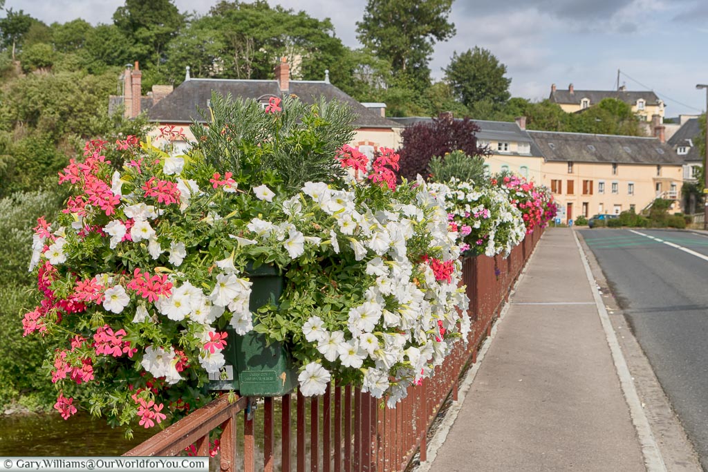A bridge, lined with flowers in windowboxes, on the  route 'La Suisse Normande' through Normandy.