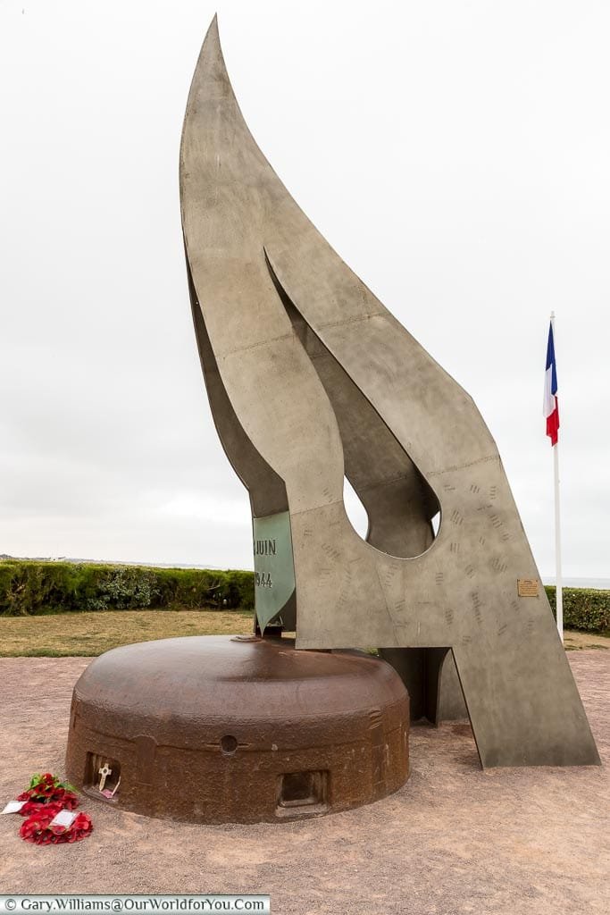 An image of the memorial "La Flamme"; a large metal flame housed on top of a German bunker.