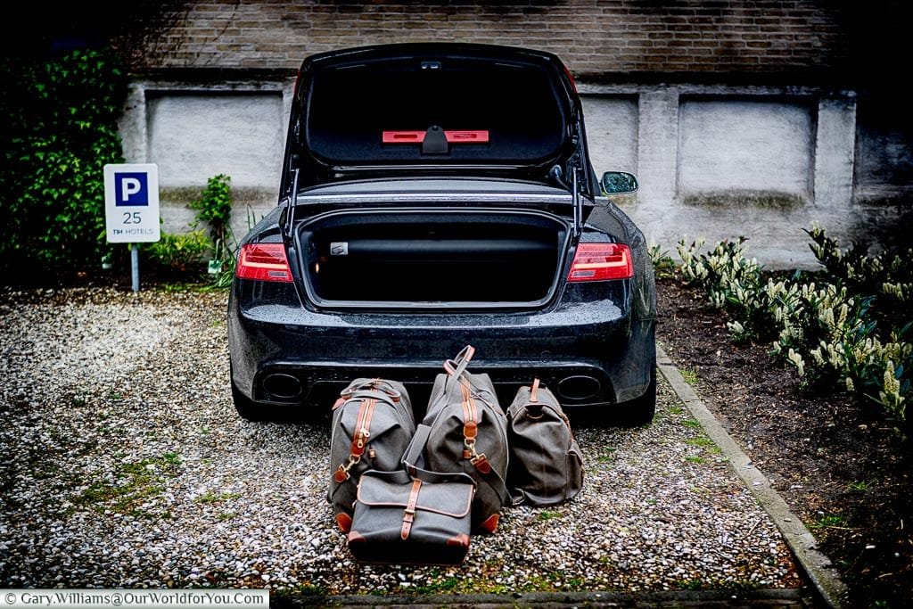Our luggage stacked in front of the opened boot of our Audi parked in our Utrecht Hotel cark park