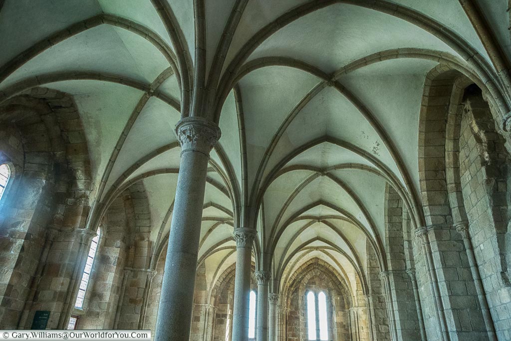 Inside the Great Hall, with its high vaulted ceiling, of Mont-Saint-Michel Abbey.