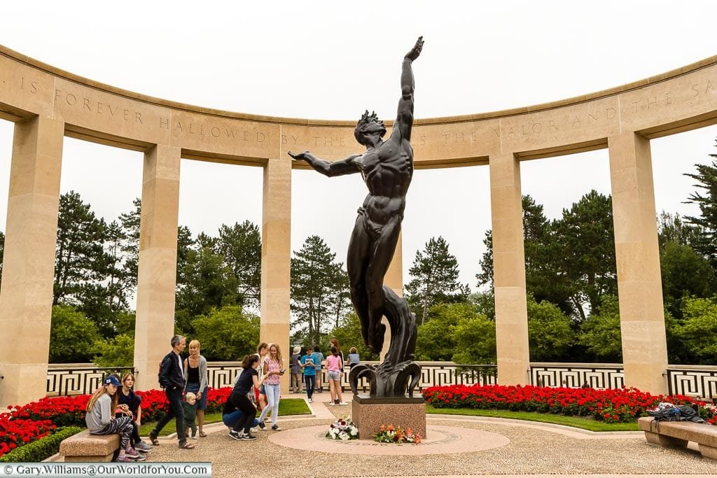 The 'Spirit of American Youth Rising from the Waves' statue in the centre of the memorial garden at the Normandy American Cemetery.