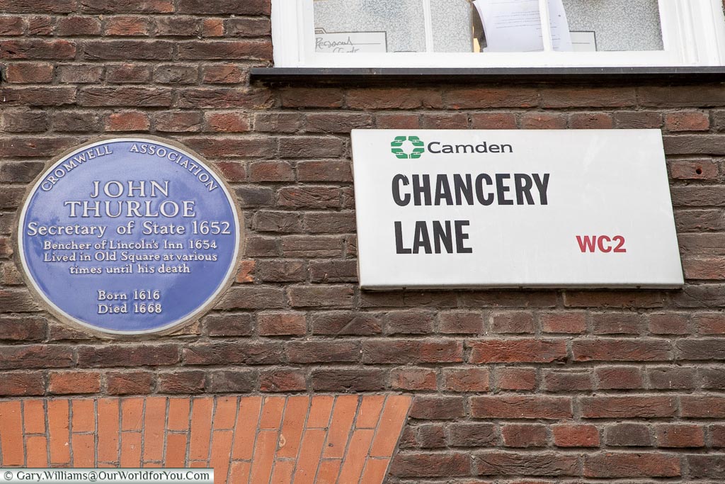 A modern street sign for Chancery Lane in the London borough of Camden WC2 next to a Blue Plaque for John Thurloe - Secretary of State - 1652