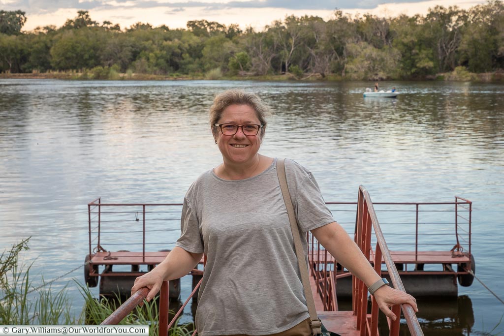 Janis standing at the edge of the Zambezi River at Victoria Falls in Zimbabwe