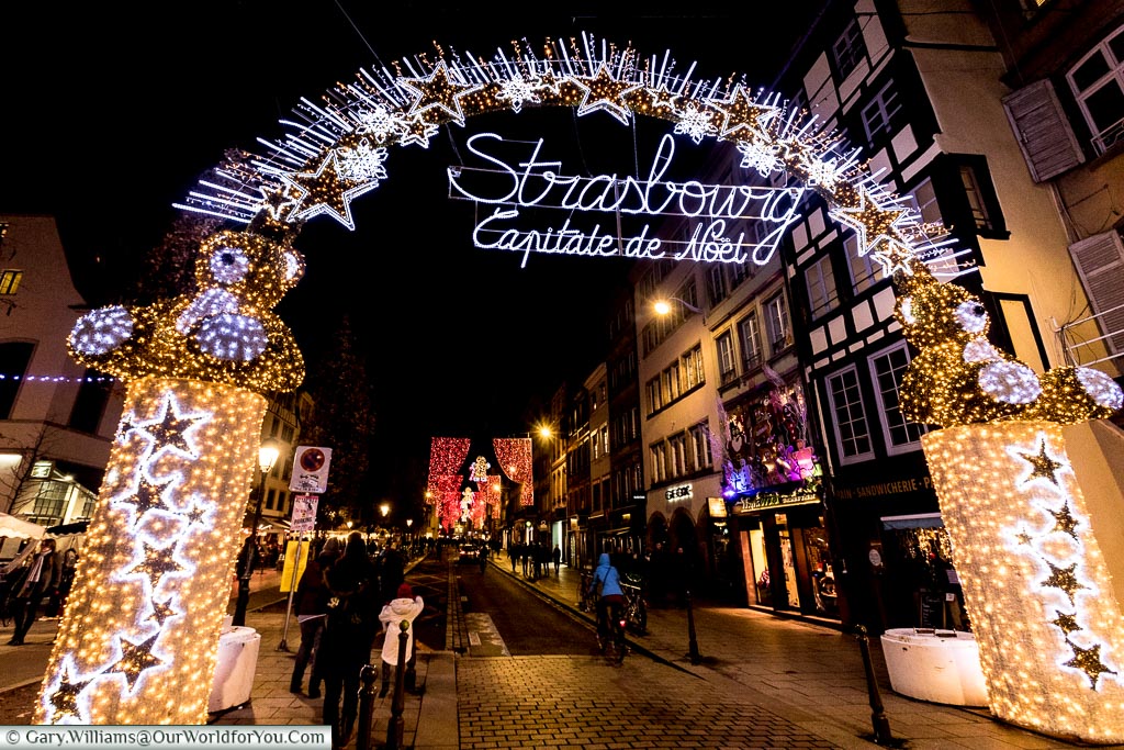 The bright illuminated arch over the Rue du Vieux-Marché-aux-Poissons that declares Strasbourg as the Capitale de Noel, or Capital of Christmas.