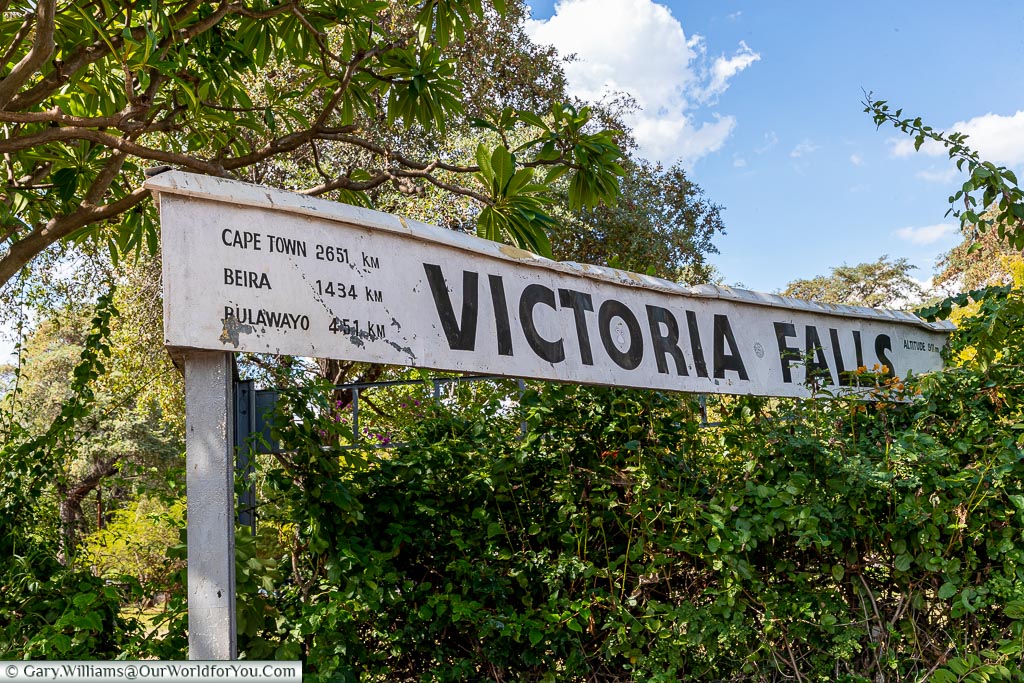 The sign for Victoria Falls station with the distances to Cape Town, Beira and Bulawayo