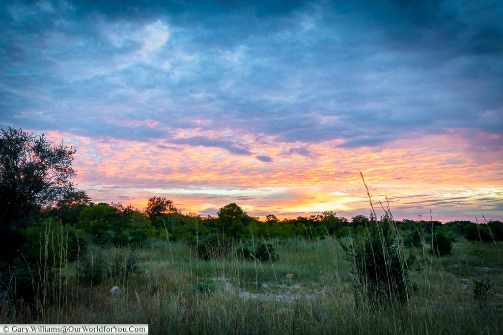 Pastel shades of a sunset over the bush in north west Zimbabwe.