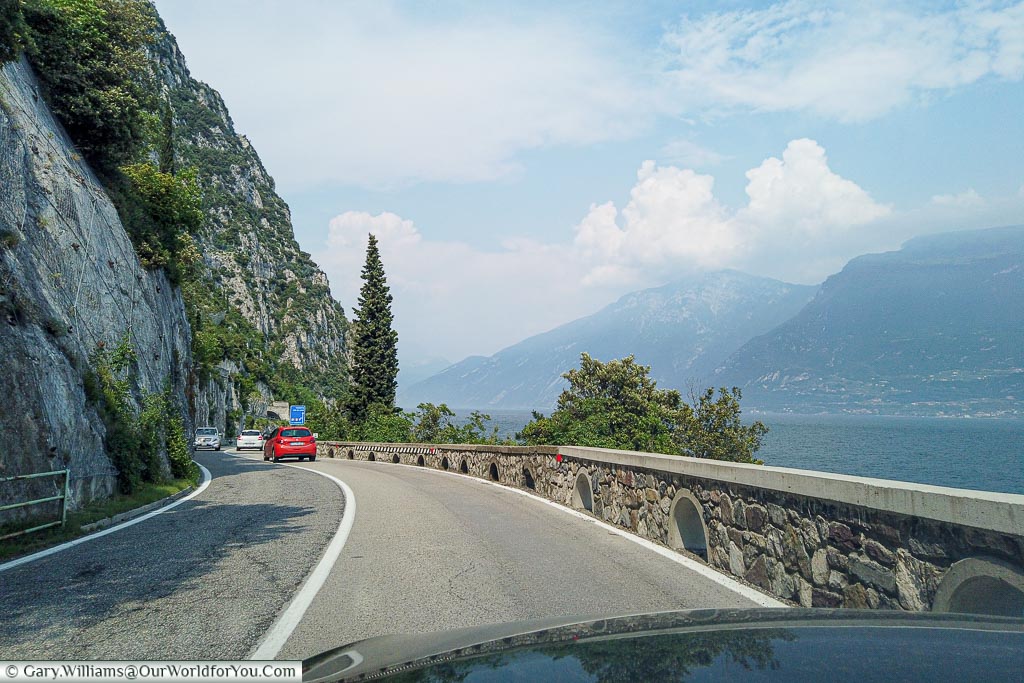 A passangers view of the road around Lake Garda, keeping a distance from the cars in front to enjoy the beauital lakes, lined by the ountains to our right.