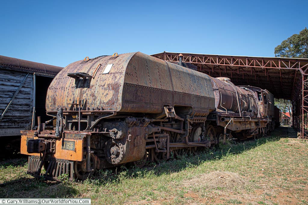 A massive Garratt steam locomotive, extensively rusted.
