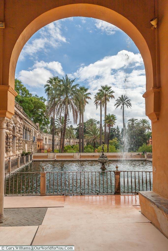 A view of the gardens through an archway in the Alcazar.