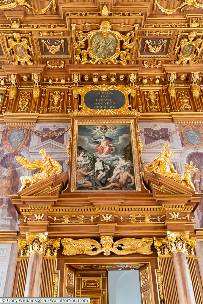 A decorated door of the Golden Hall with an ornate painting above it.