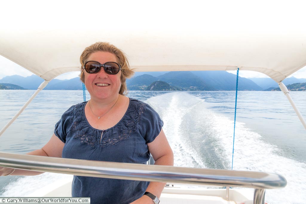 Janis at the controls of a powerboat on Lake Como