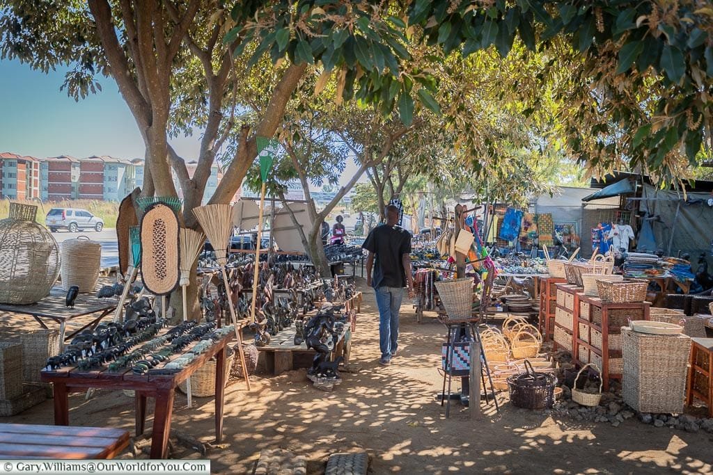 Stalls on the left & right displaying local wares.