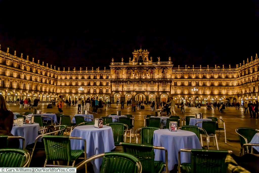 The view Plaza Mayor in Salamanca, illuminated at night, from a table of a bar.