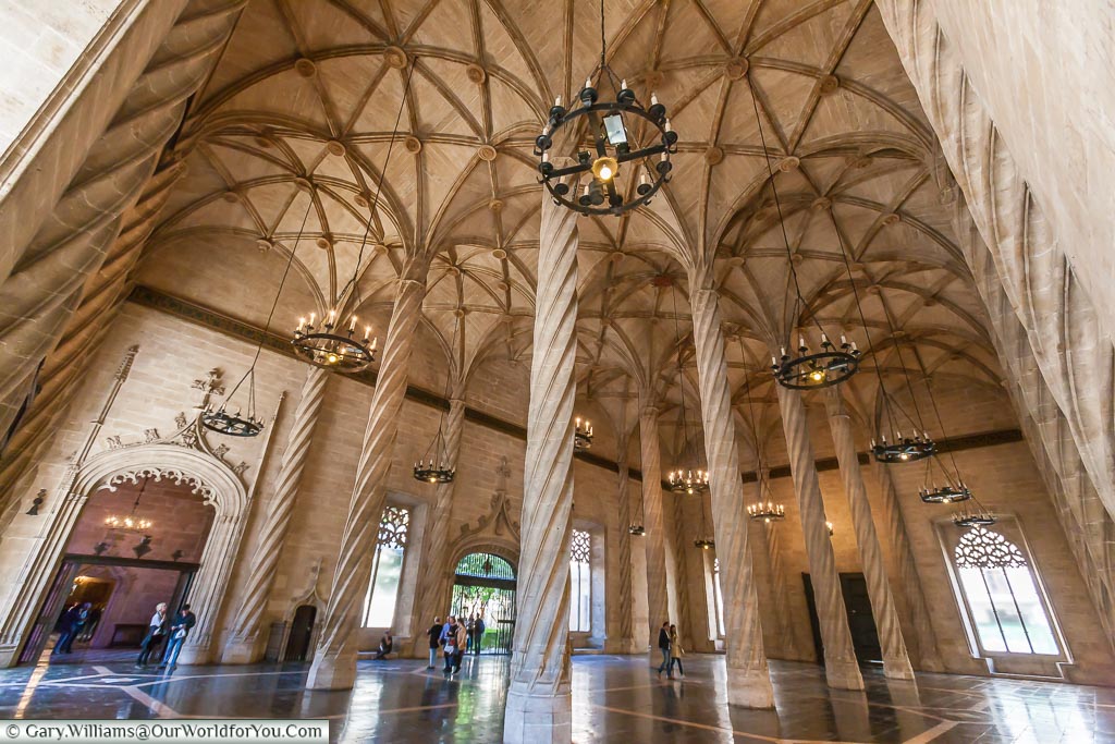 Inside the Silk Exchange of Valencia with its high vaulted roof and spiral columns.