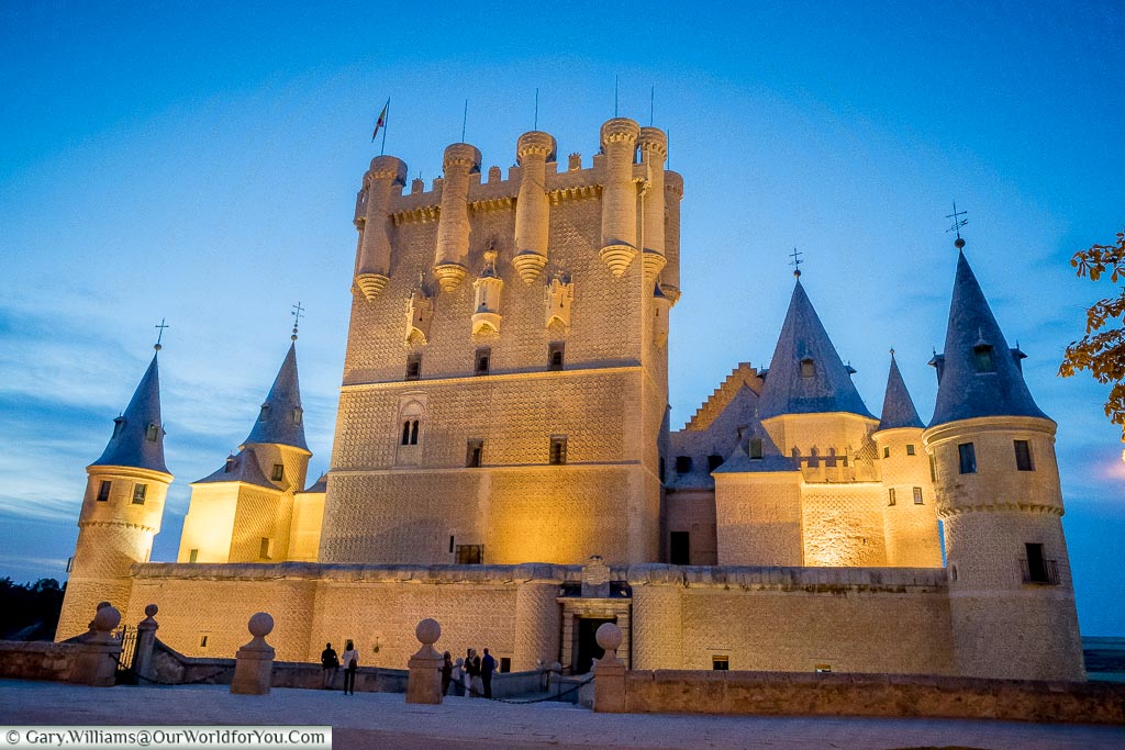 The illuminated entrance to the Alcazar of Segovia.