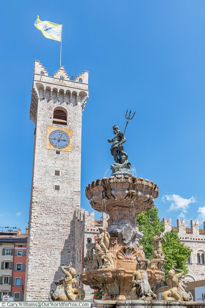 Looking up at the Neptune Fountain with the Torre Civica in the background from the Piazza Duomo.