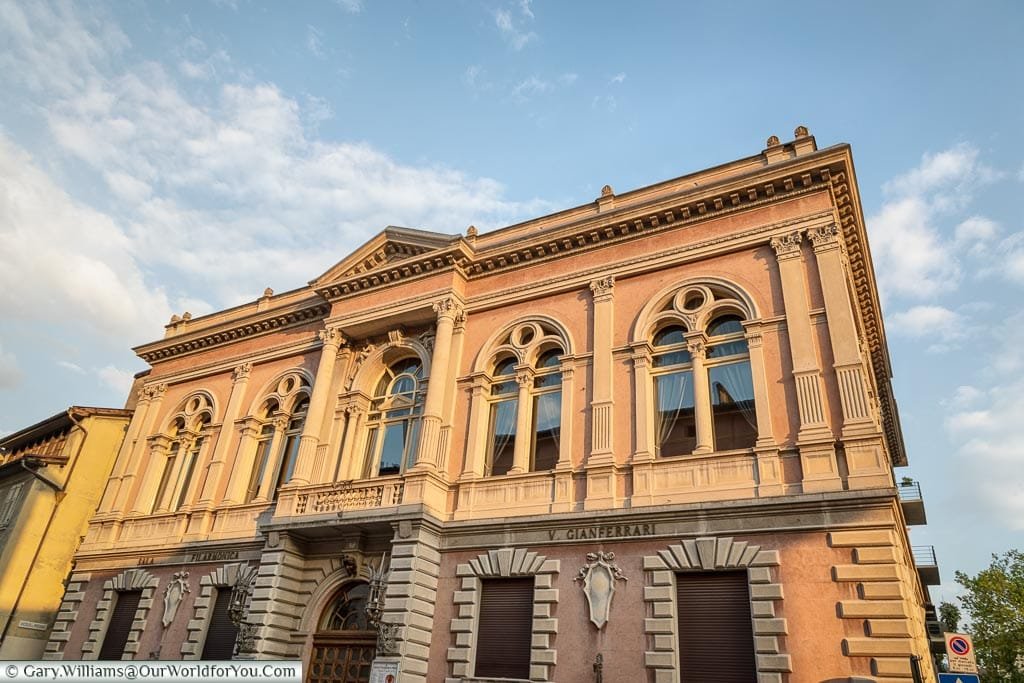 The exterior of a neoclassic building the houses the Trento Philharmonic.