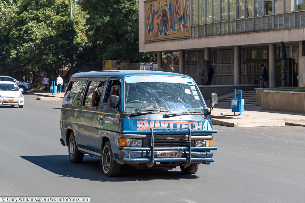 A well used Nissan minibus serving as a commuter bus in central Harare.