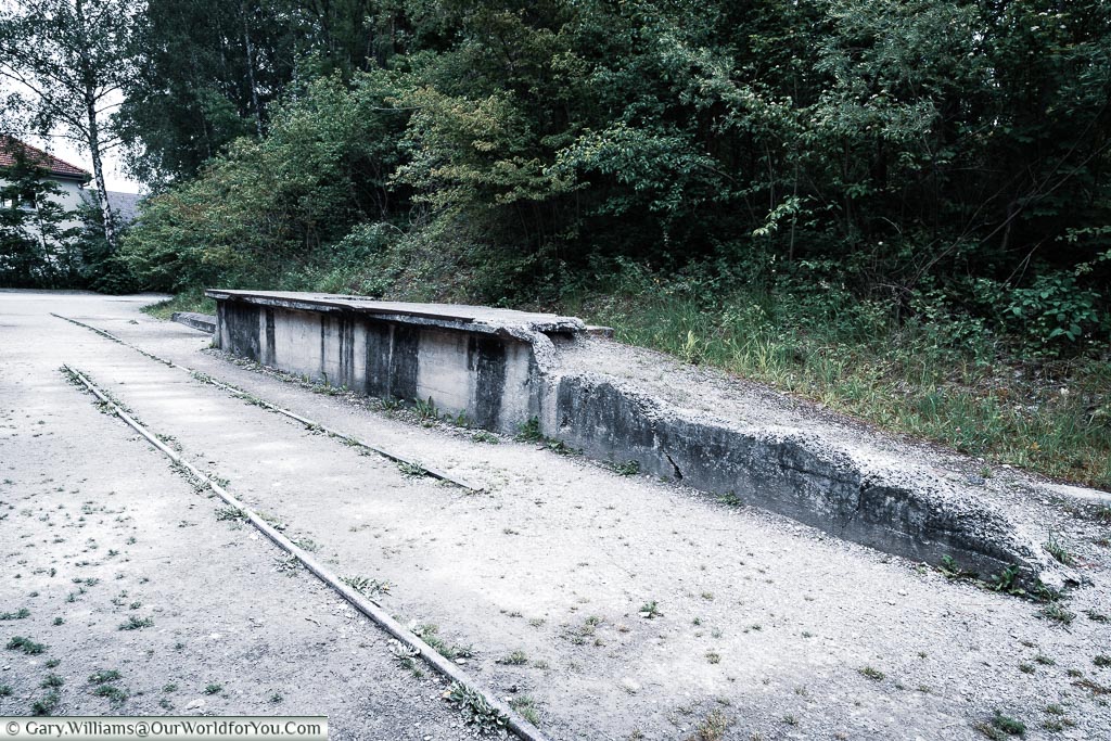 The railroad tracks in front of a crumbling platform that was once the disembarkation point of prisoners to the camp.