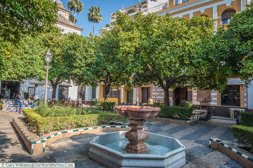 A small red marble fountain in the centre of one of the many small squares you find yourself getting lost in in Seville