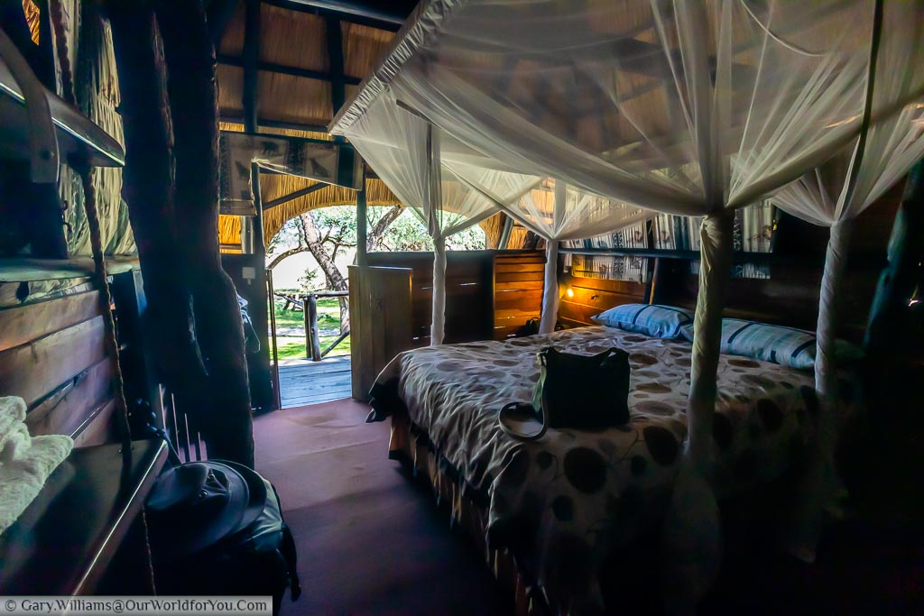 Inside our Tree Lodge at Sukumi with the mosquito nets fixed to the bed, looking out to the veranda.