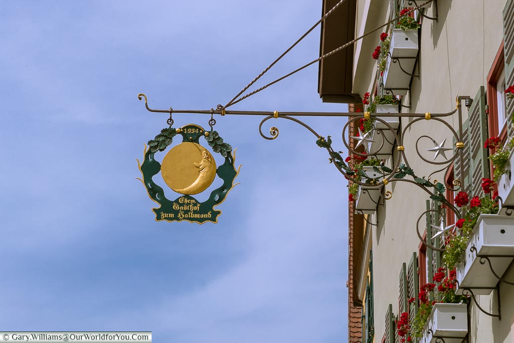 A beautiful, traditional, smiling man-on-the-moon wrought iron Inn sign.