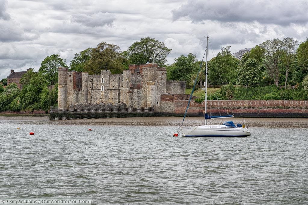 A view across the choppy River Medway, in Kent, to Upnor Castle on the far bank. A small sailing boat is anchored in the centre of the River