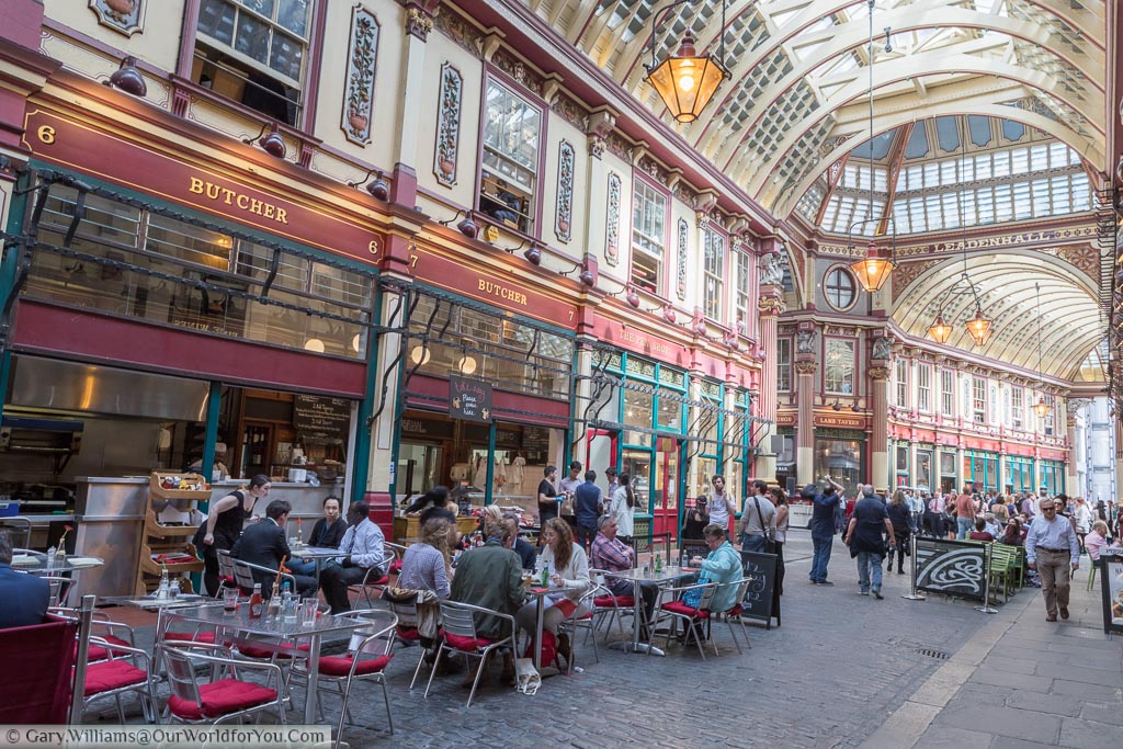 Tables and chairs filled the cobbled streets of Leaden Hall market in the City of London as diners taking lunch.