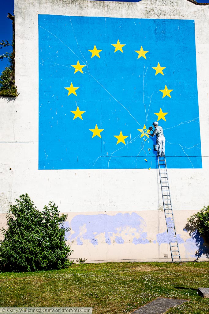 The mural of a worker chipping off a star from the EU flag by Banksy near one of the UK's major ports in Dover.