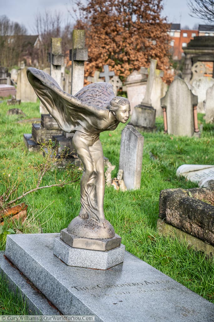 The grave of Thea Canonero Altieri at Kensal Green Cemetery, decorated with a winged lady, similar to the spirit of ecstasy bonnet ornament on a Rolls-Royce car.
