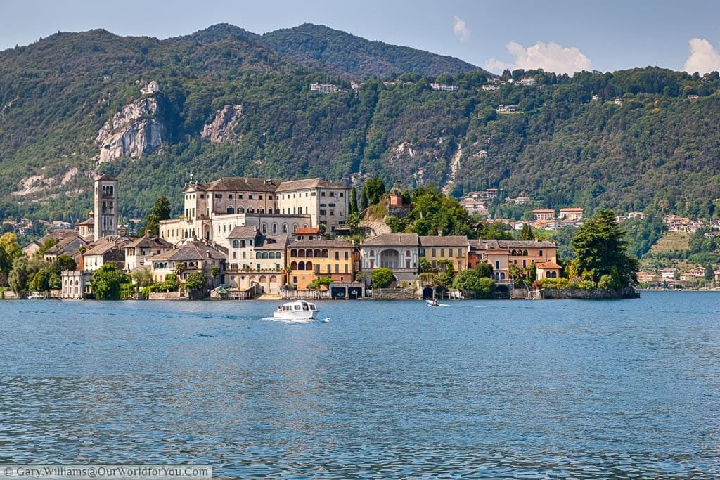 A boat returning from Isola San Giulio on Lake Orta where the convent and church dominate this historic little island. Again the backdrop is green mountains.
