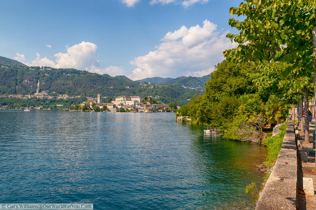 A view of Lake Orta from the tree lined path that leads into Orta San Giulio.  In the distance you can see Isola San Giulio dwarfed by the hills that surround the lake.