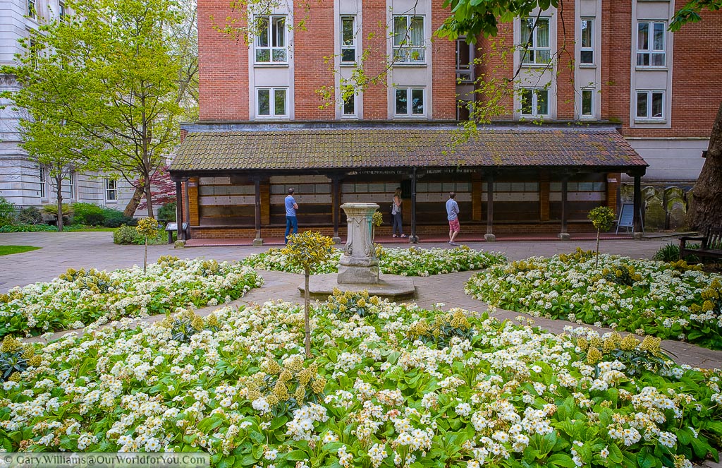 The flower beds in Postman's park in the City of London in front of the memorial for heroic sacrifice.