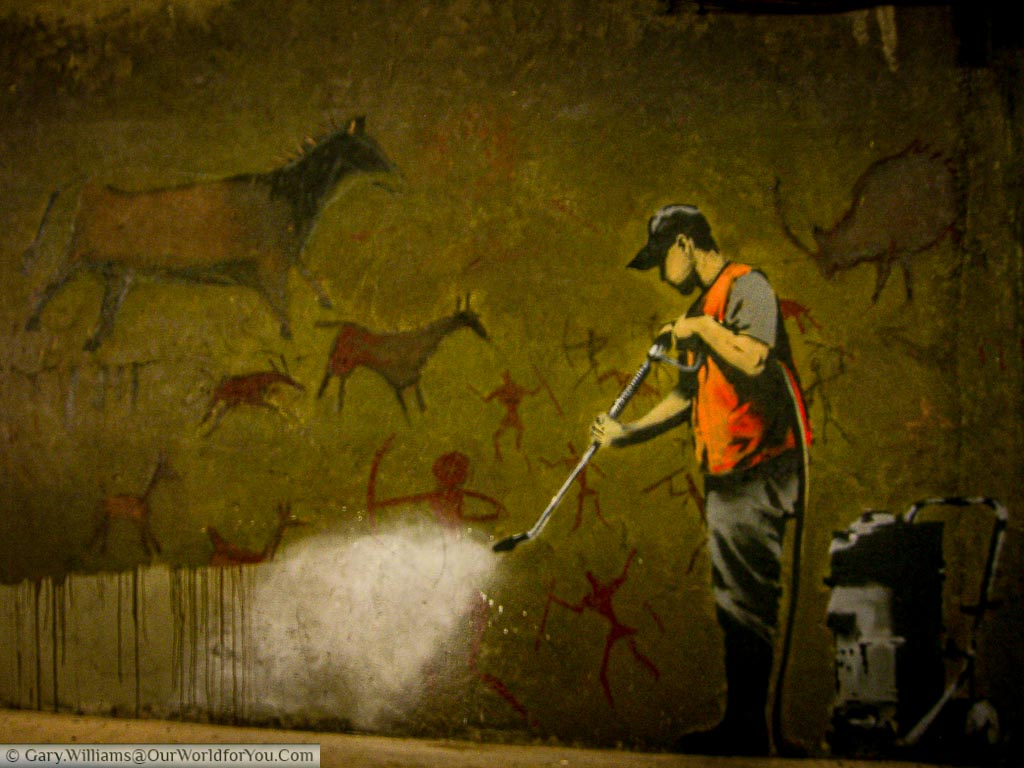 The Banksy piece - Graffiti Removal captured at the 'Cans Festival'.  It depicts a worker in a hi-vis vest jetwashing cave paintings away.