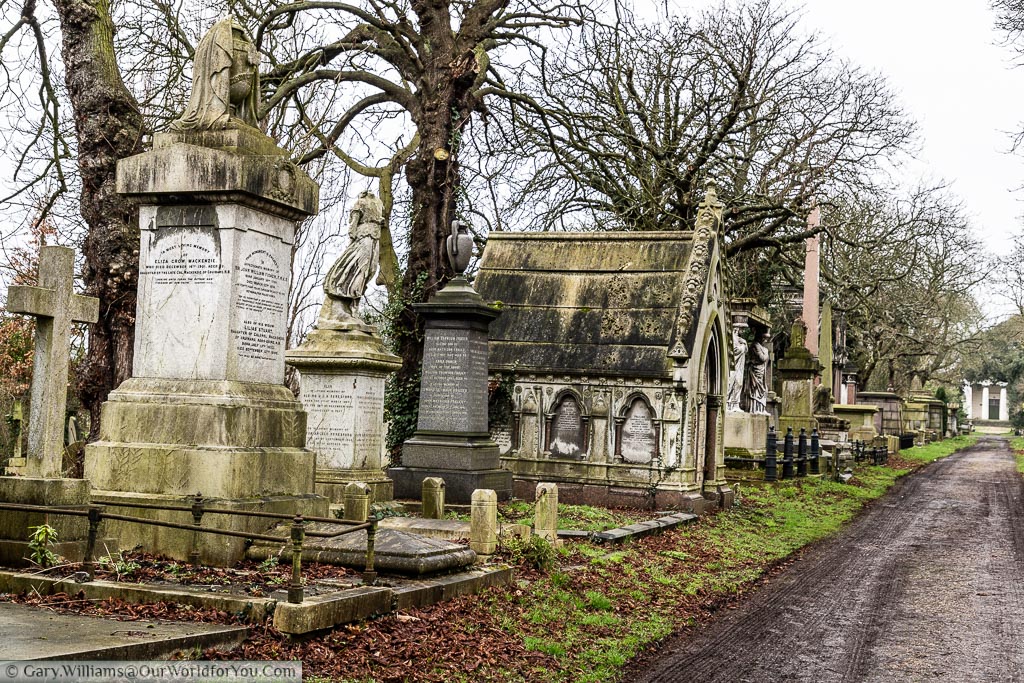 A series of historic tombs and headstones line the path to the chapel at the centre of Kensal Green Cemetery