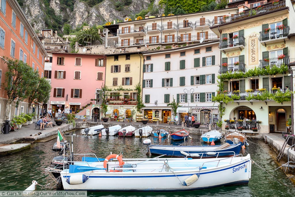 Looking across the tiny harbour of Limone Sul Garda to the Restaurants in gift shops that line the streets of this pretty little town on Lake Garda.