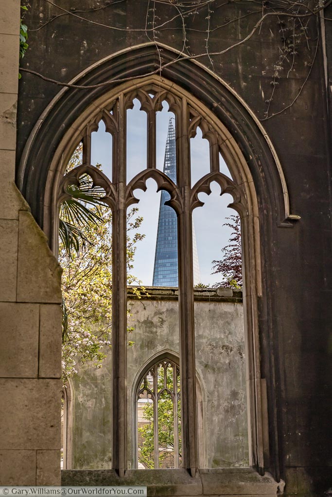 View through the window of a derelict church to the Shard skyscraper in the City of London