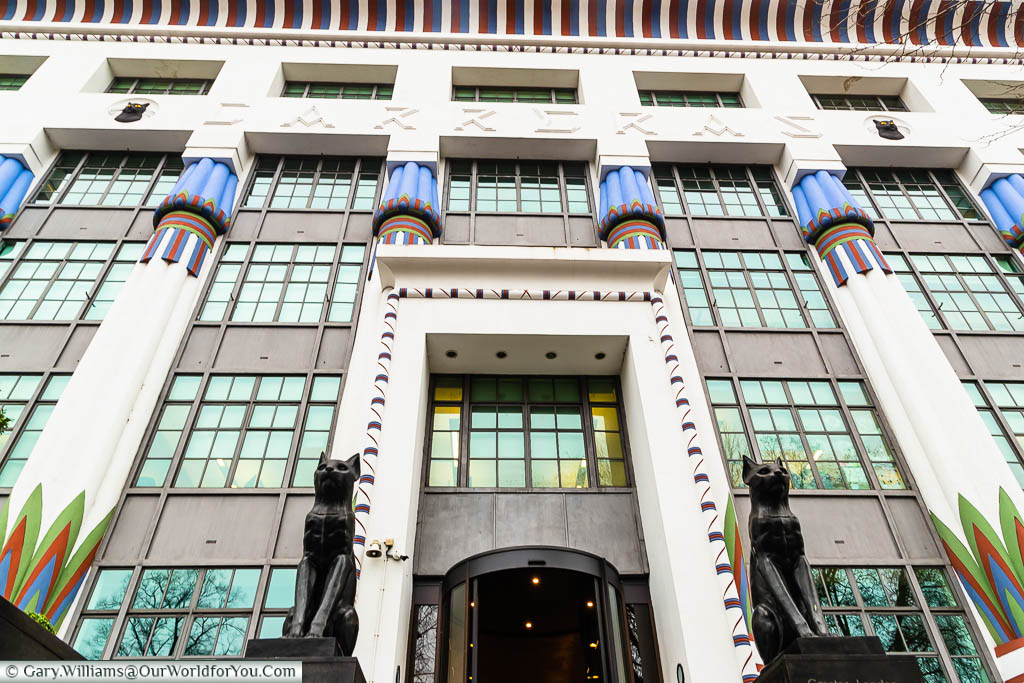 The Art Deco facade to London House, formerly the Carreras Cigarette Factory, with its two Egyptian bronze cats standing guard at the front of the building.