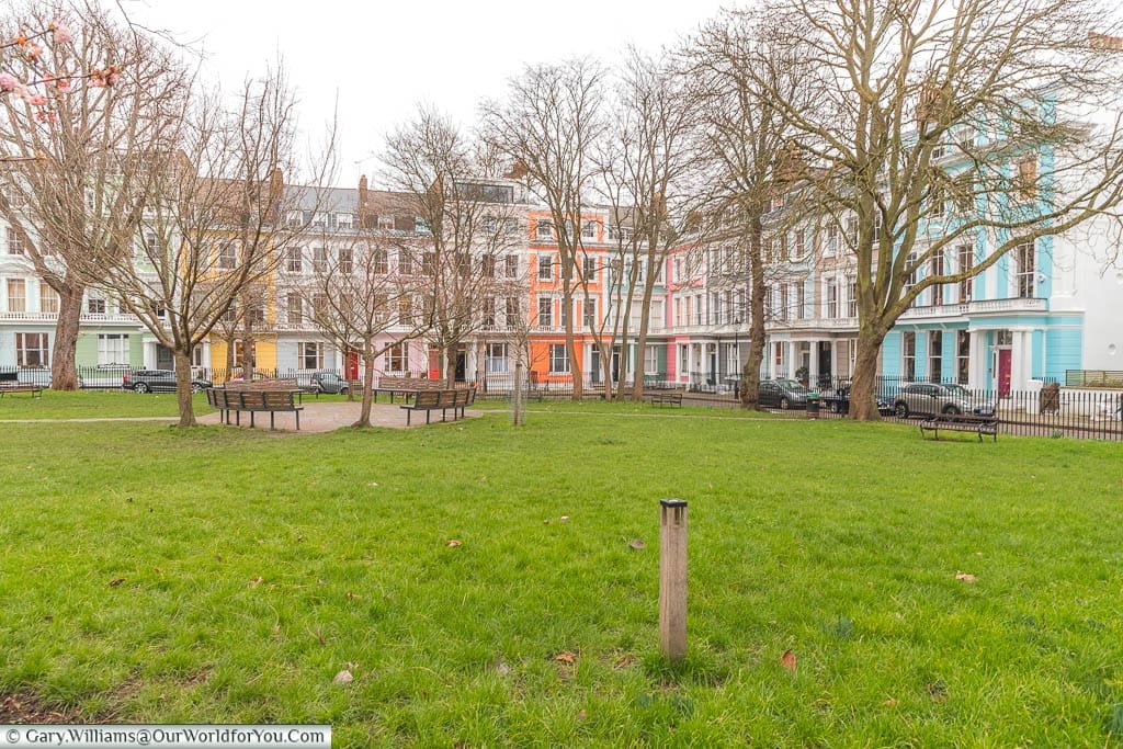 A public garden in Primerose Hill surrounded by colourful Georgian townhouses.