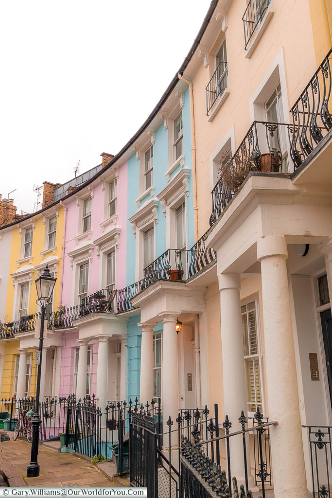 A row of pastel-coloured Georgian homes in along Chalcot Crescent, Primrose Hill