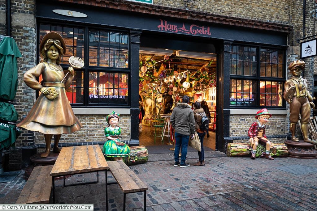 Playful statues of the titular characters frame the outside of the Hans & Gretel sweet store in the North Yard of Camden Market.