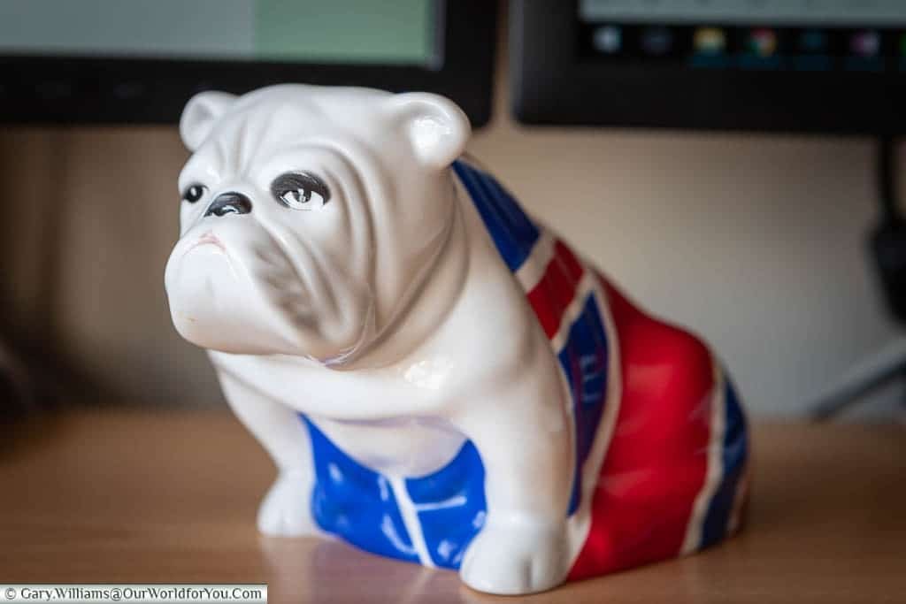 A Royal Doulton china Bulldog, in a seated postion, wearing a Union Jack 'coat' on my desk at home. This is the same piece that features in the James Bond movie 'Skyfall'.